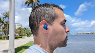 Our reviewer wearing the Phiaton BonoBuds wireless earbuds