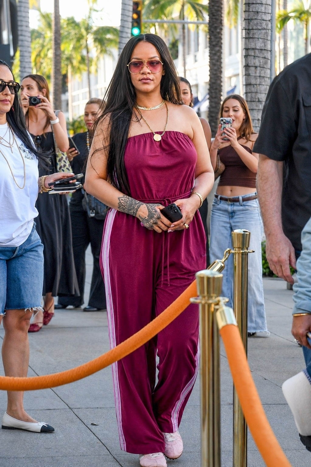 Rihanna styled a strapless sporty jumpsuit with track pant-inspired stripes up each side