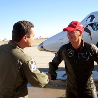 Former NASA space shuttle commander Rick "CJ" Sturckow smiles and shakes hands after flying Virgin Galactic's SpaceShipTwo to a landing at California's Mojave Air and Space Port after a glide test flight on Jan. 17, 2014.