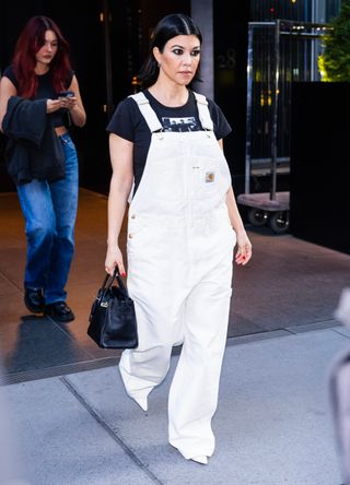 Kourtney Kardashian wearing white dungarees