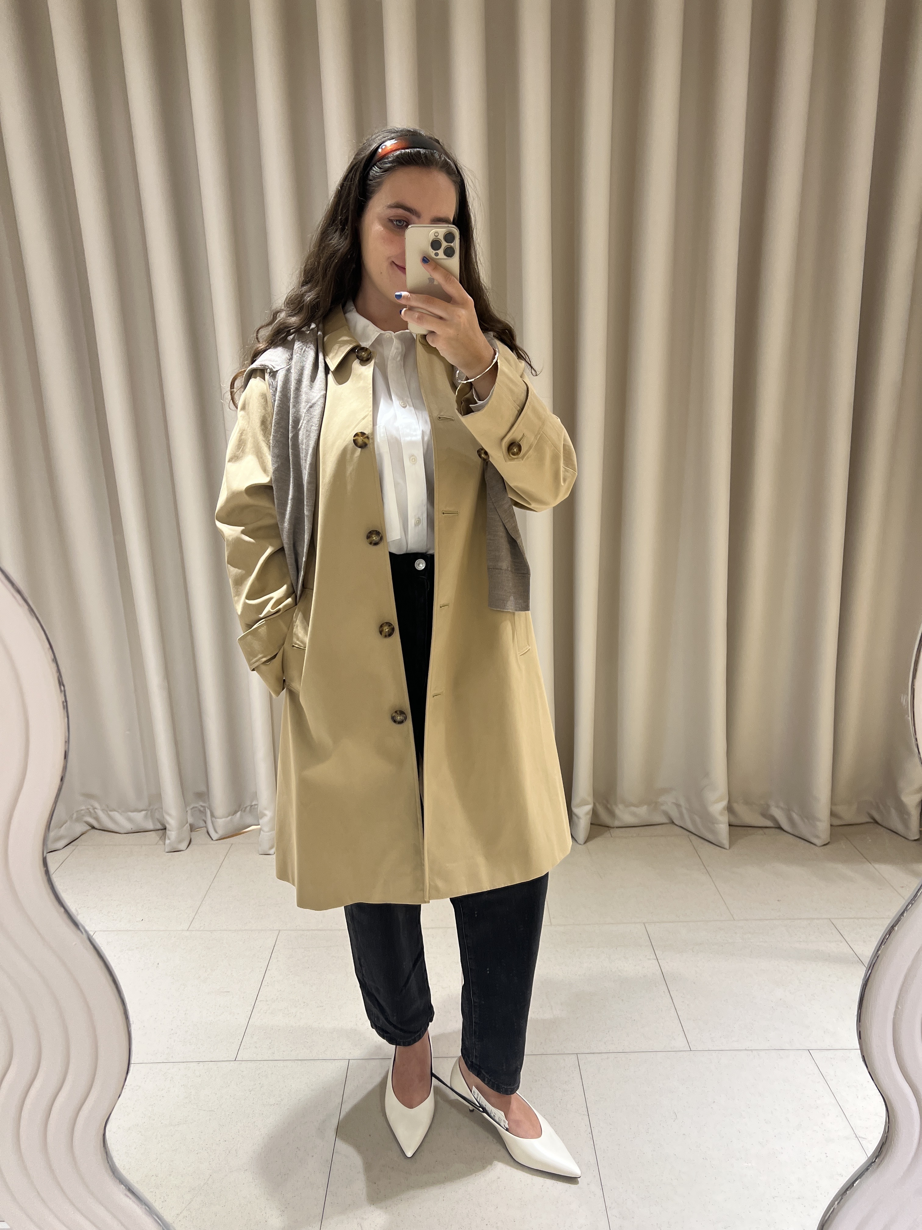 An image of Who What Wear UK fashion writer Ava Gilchrist wearing M&S's new Spring 2026 collection, consisting of black jeans, a white shirt, court shoes and a camel car coat.