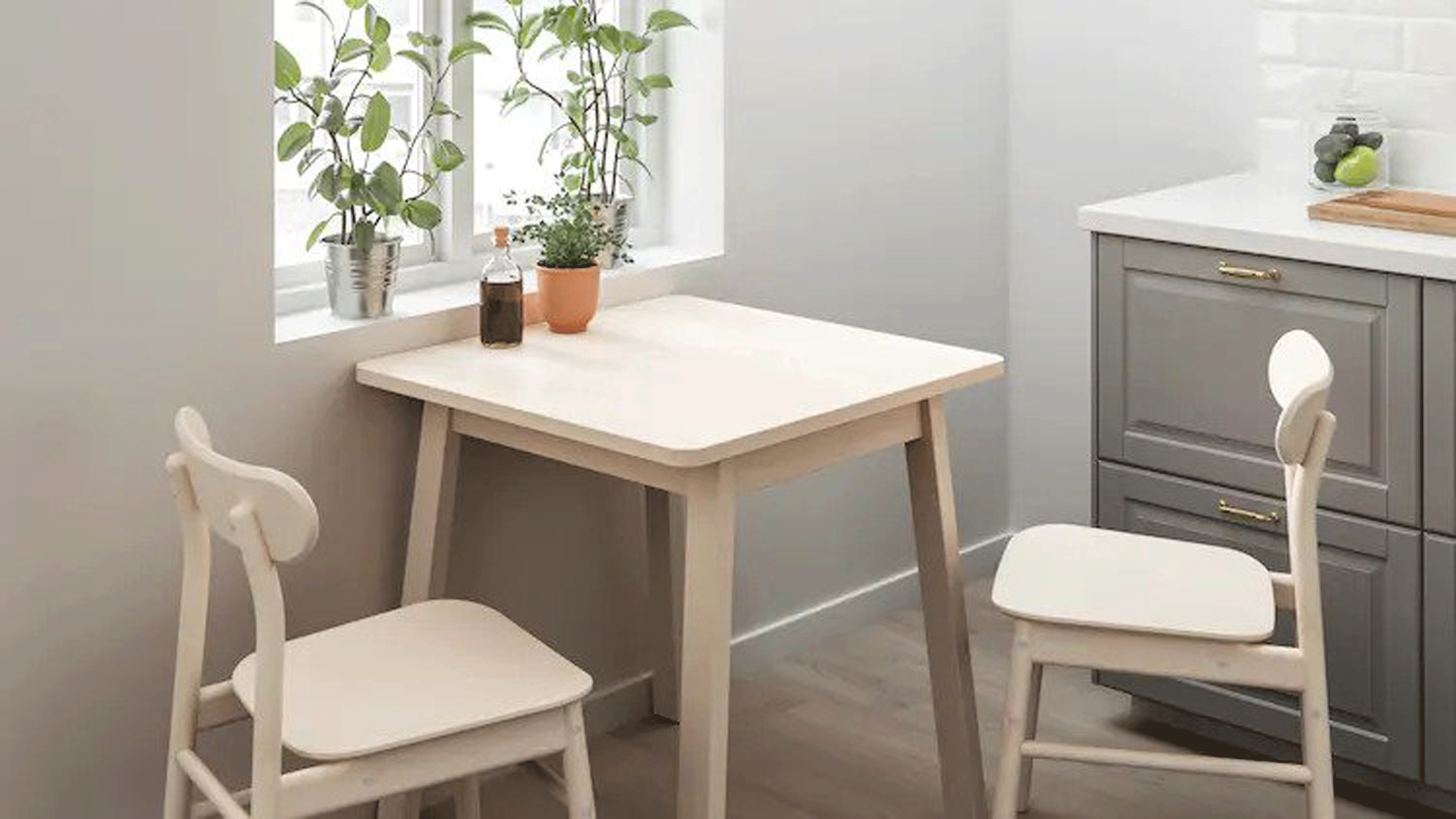 White cabinets, dark grey walls, and window with hanging plant