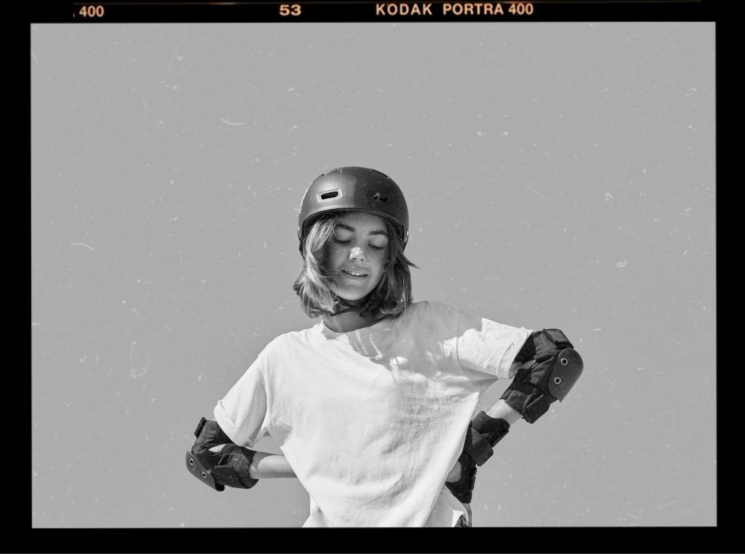 Young girls playing a variety of different sports: football, rollerblading, basketball, rock climbing and swimming