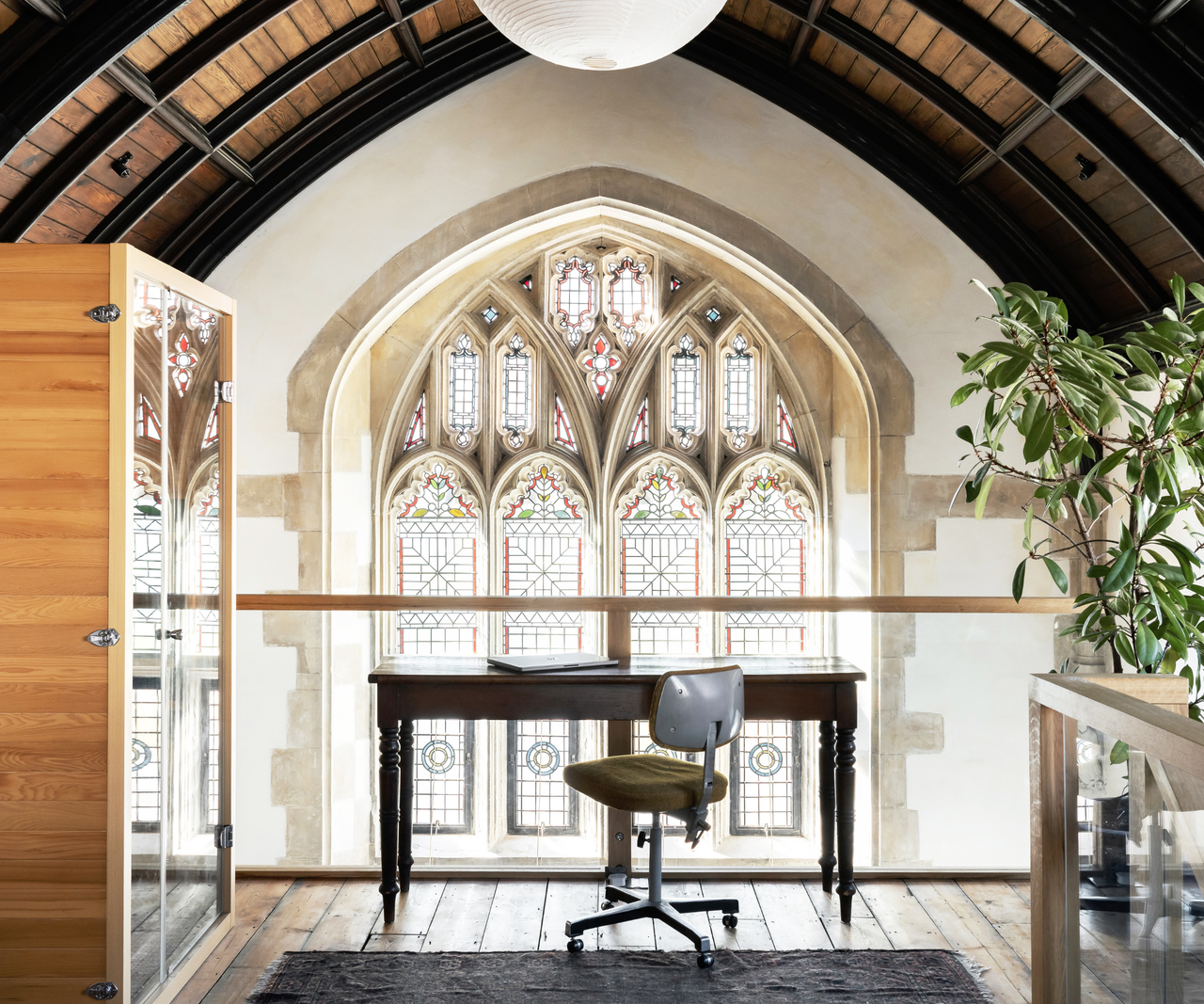 Top of the mezzanine with a desk facing the large stained glass window