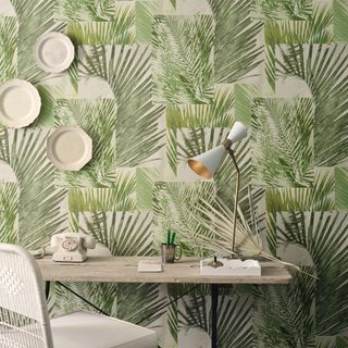 botanical print wallpaper behind wooden desk and chair