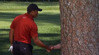Tiger Woods shakes hands with Verne Lundquist in the final round of The Masters