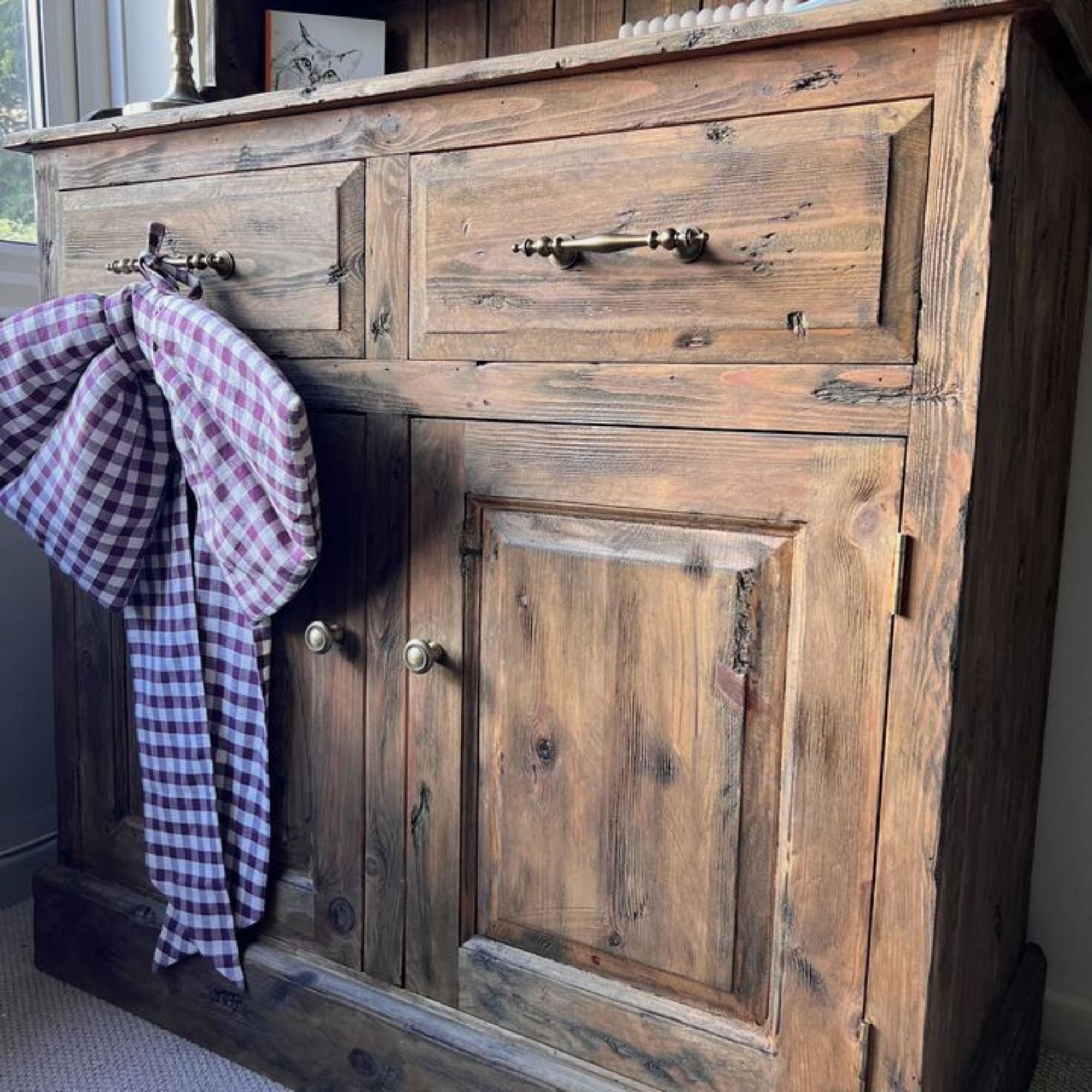 The bottom half of a distressed, upcycled medium oak Welsh dresser.