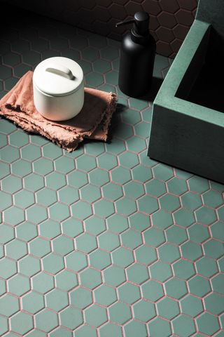 hexagonal green bathroom floor tiles with pink grout