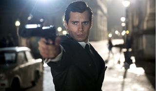 The Man From U.N.C.L.E. Henry Cavill takes aim in the streets of Berlin