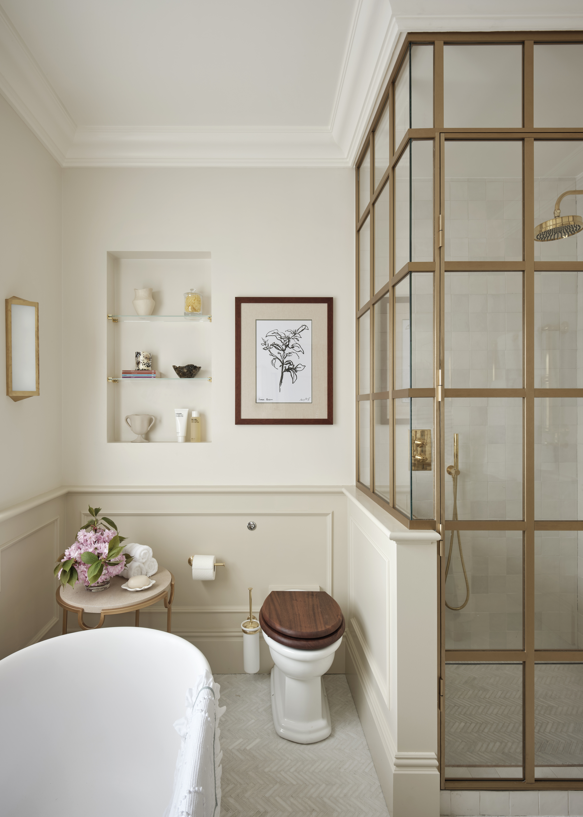 A small bathroom including a shower cubical with a crittall-style door, a tub, and and a toilet