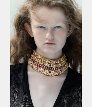 woman with red hair wearing jewellery