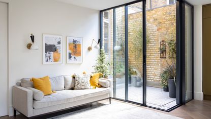 Living room looking out onto small patio courtyard with sliding doors