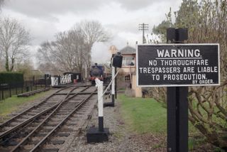 There are often interesting subjects around the track – here, for example, a warning sign as the train arrives in the background