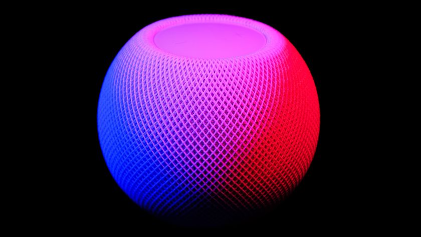 Apple HomePod mini on black background