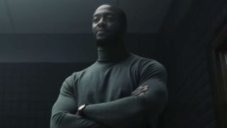 Aldis Hodge as Alex Cross in an interrogation room with his arms folded on Cross