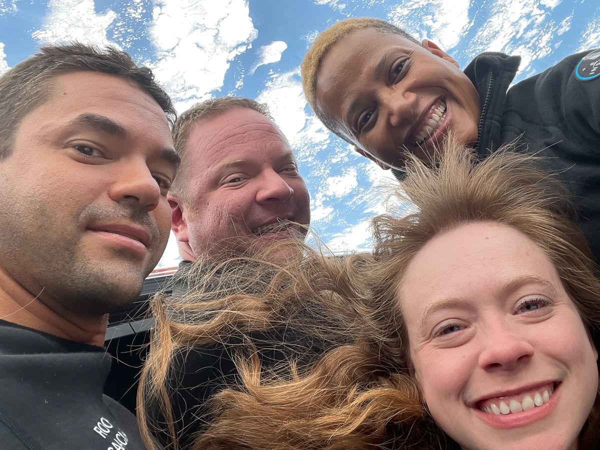 The Inspiration4 crew poses for a selfie in the Crew Dragon cupola.