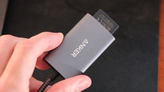 Anker PowerExpand+ 2-in-1 SD 4.0 Card Reader held in two fingers