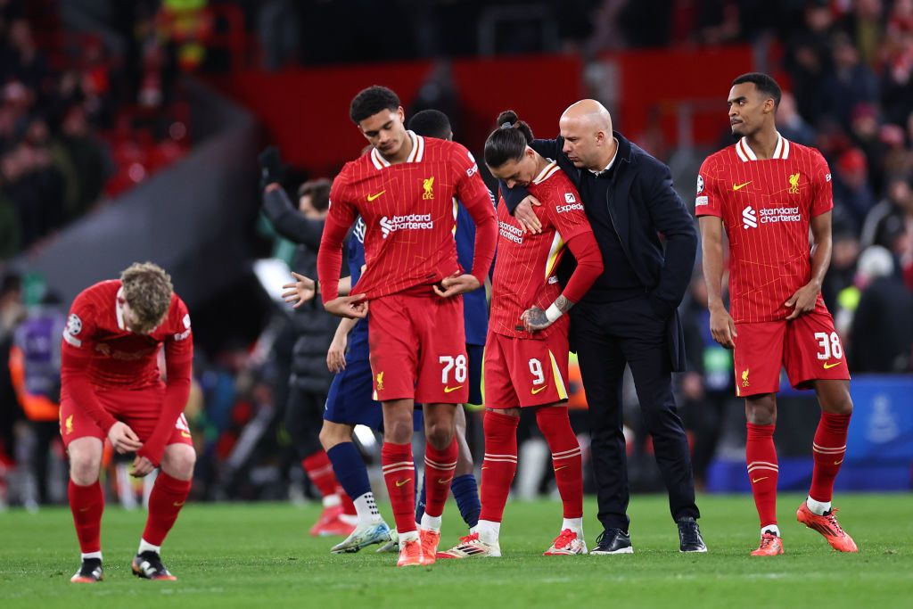 Arne Slot puts his right arm around Darwin Nunez with disconsolate Liverpool players around him following Liverpool&#039;s penalty shoot out defeat to PSG in the Champions League 