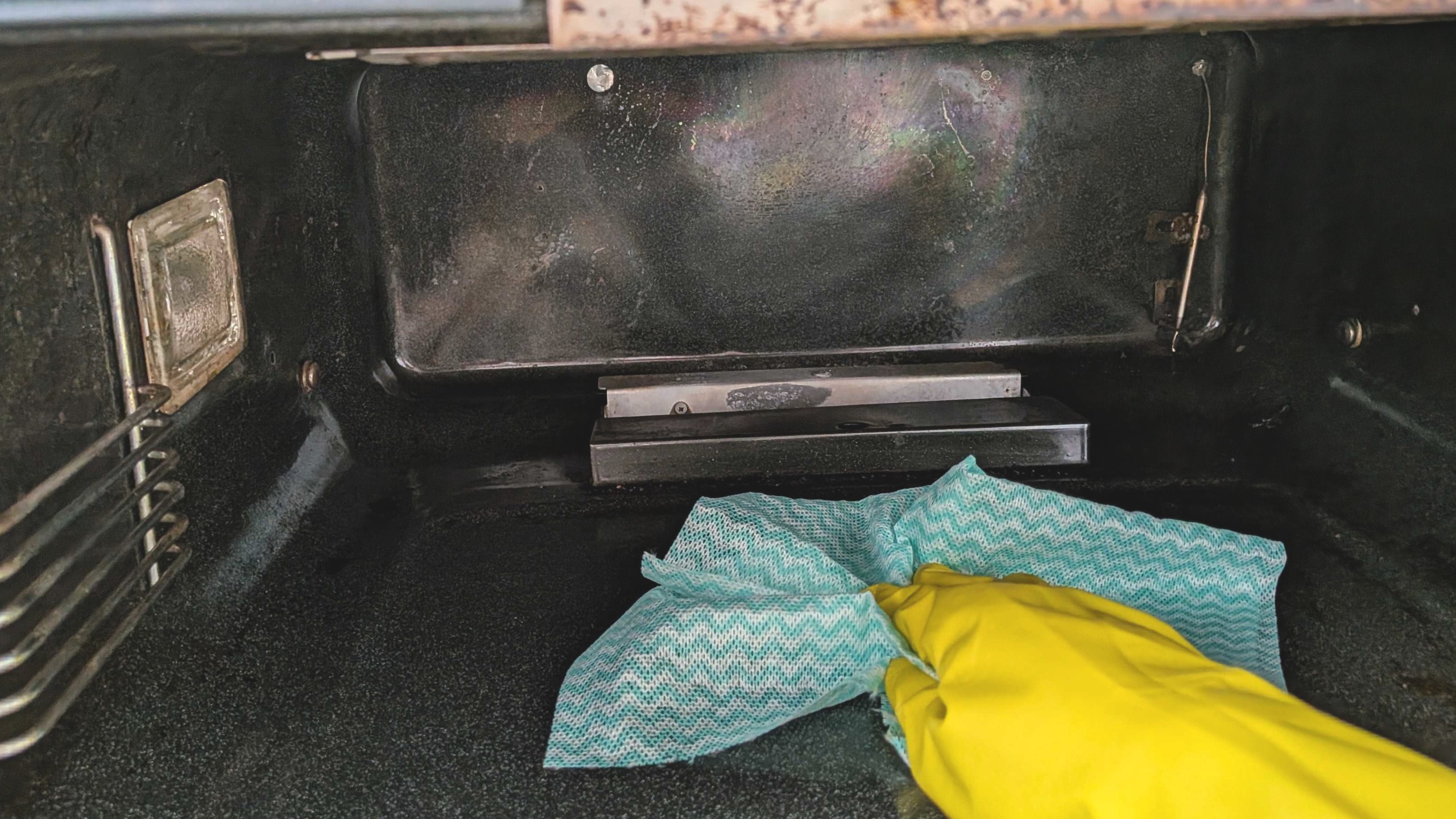 Cleaning inside oven with cloth