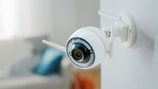 Interior home security camera mounted on wall