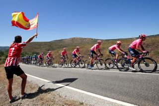 ESPINOSA DE LOS MONTEROS SPAIN AUGUST 16 A general view of Jonathan Klever Caicedo Cepeda of Ecuador Diego Andres Camargo Pineda of Colombia Simon Carr of United Kingdom Hugh Carthy of United Kingdom Magnus Cort Nielsen of Denmark Lawson Craddock of United States Jens Keukeleire of Belgium Thomas Scully of New Zealand and Team EF Education Nippo and the peloton while fans cheer during the 76th Tour of Spain 2021 Stage 3 a 2028km stage from Santo Domingo de Silos to Espinosa de los Monteros Picn Blanco 1485m lavuelta LaVuelta21 CapitalMundialdelCiclismo on August 16 2021 in Espinosa de los Monteros Spain Photo by Gonzalo Arroyo MorenoGetty Images