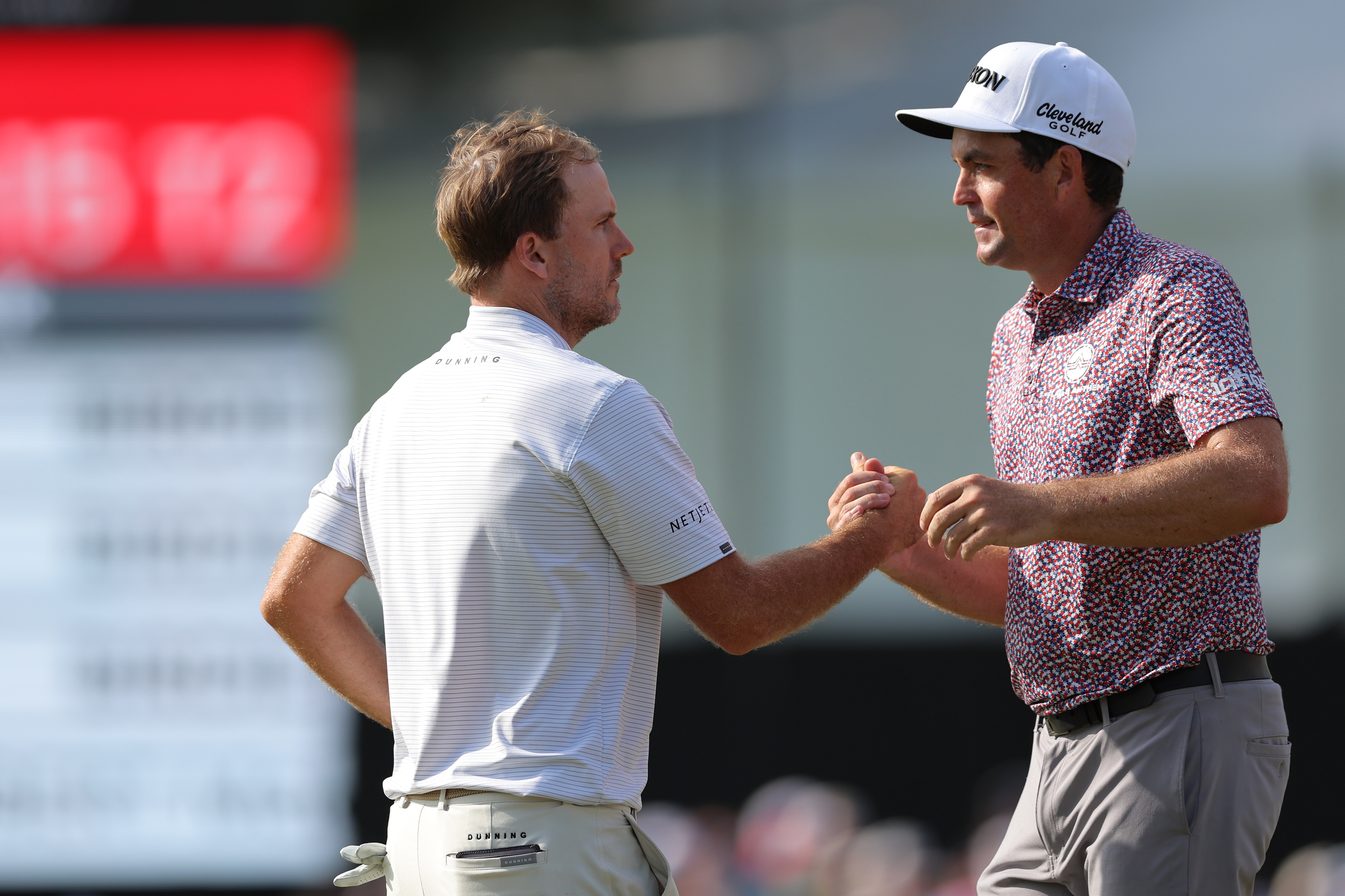 Russell Henley and Keegan Bradley shake hands