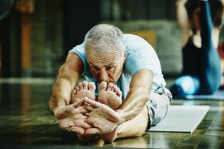 Senior man stretching his legs