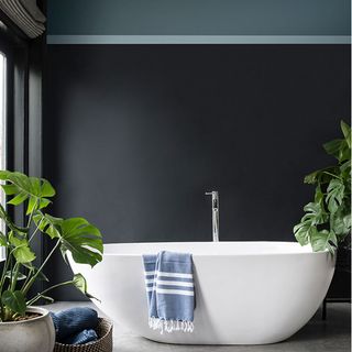 bathroom with bathtub and grey shade wall