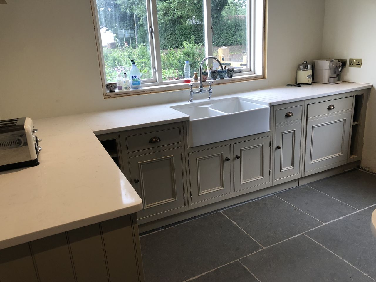The finished kitchen with secondhand taupe kitchen units and white quartz worktop