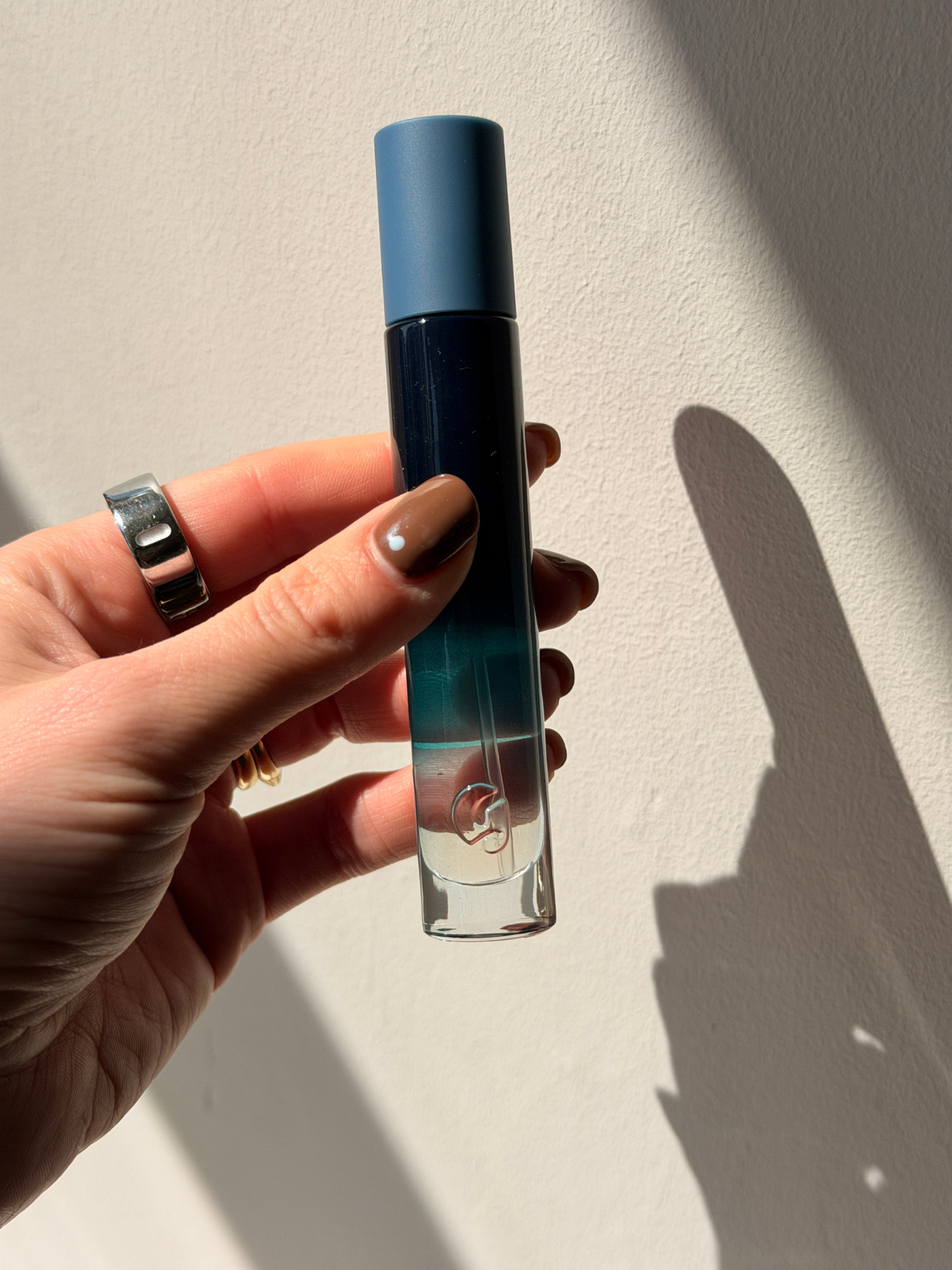 Beauty contributor Grace Day holding the Glossier You Soie perfume