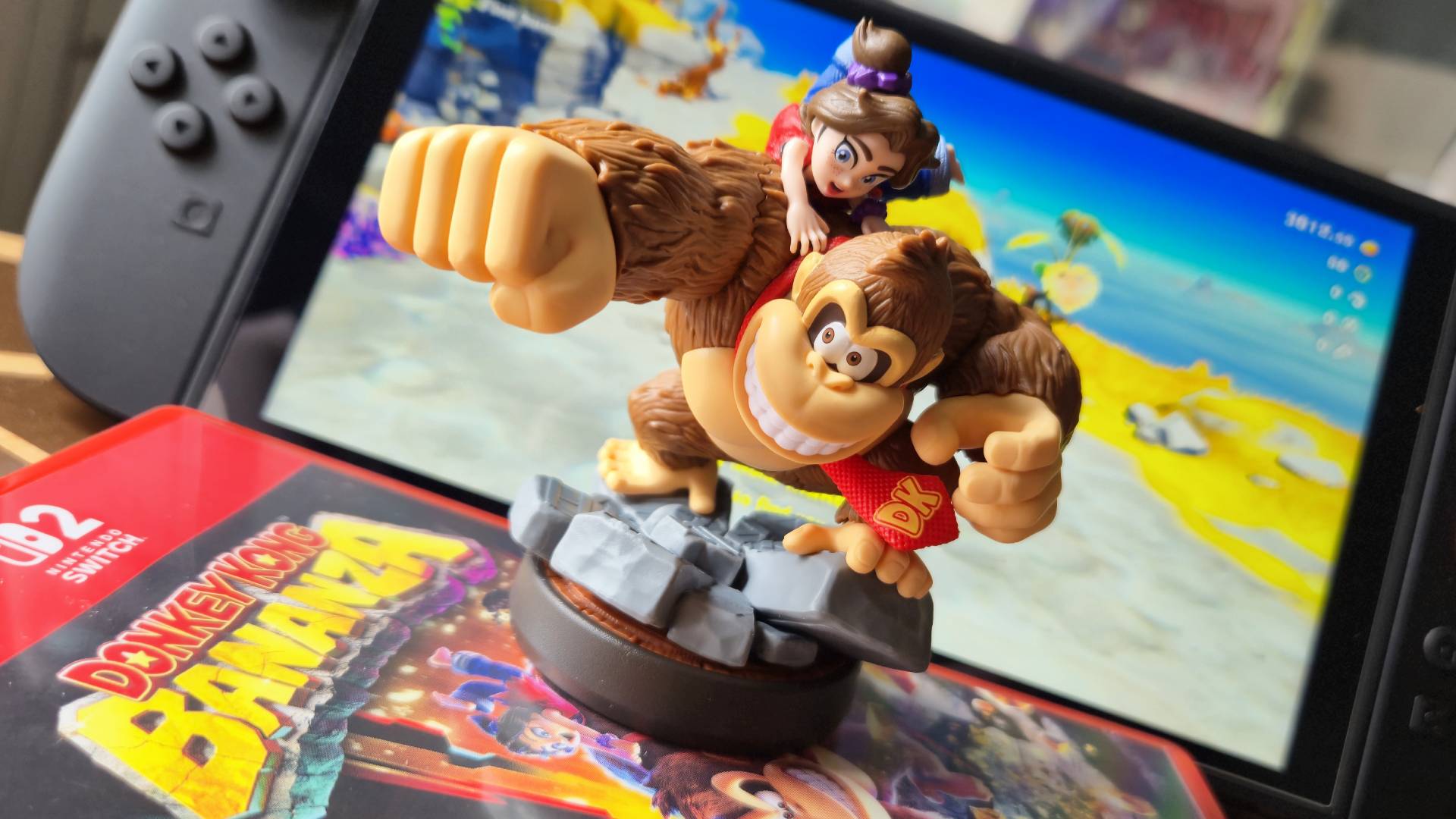 Photo by Rosalie Newcombe of the Donkey Kong and Pauline amiibo standing in front of a Nintendo Switch 2.