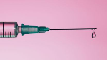 a needle on a pink background 