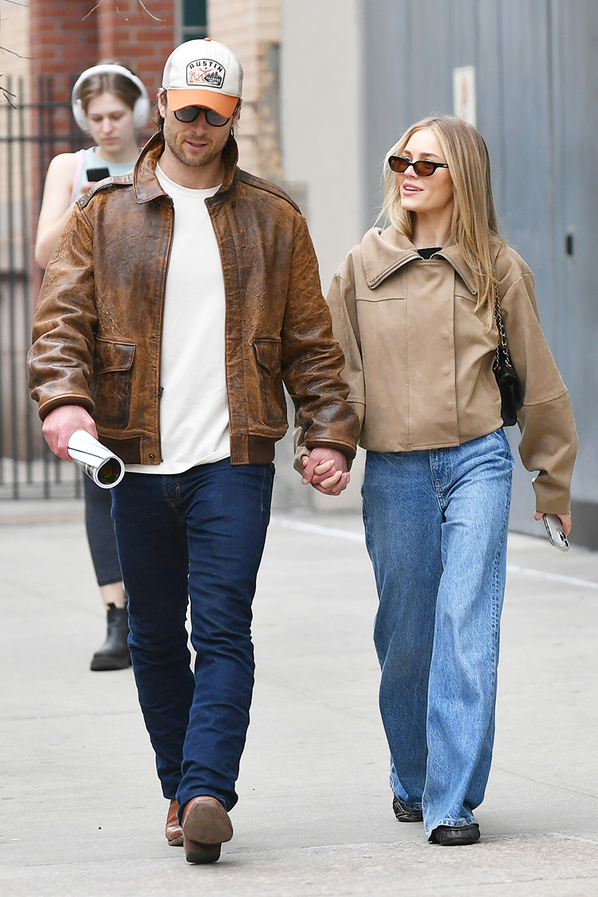 Glen Powell and Michelle Randolph walking in NYC wearing tan jackets and jeans