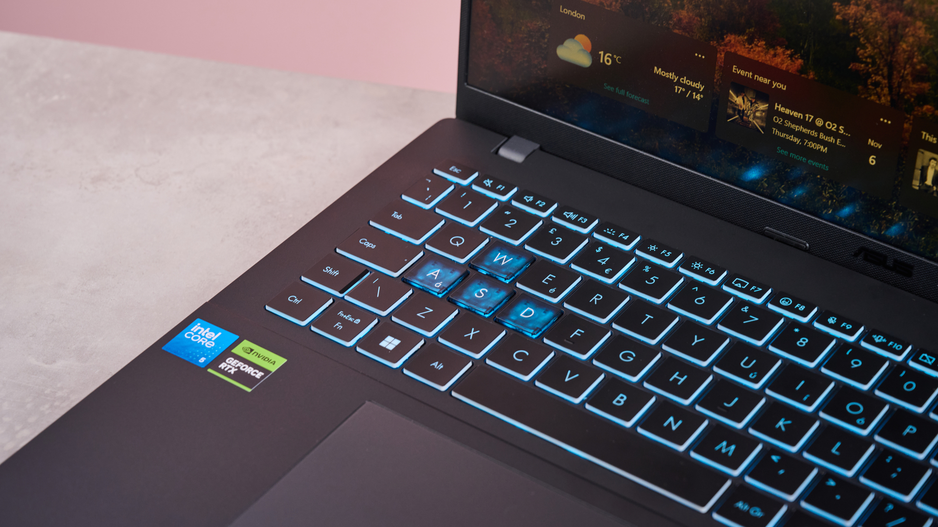 Close-up of left side of keyboard with blue backlighting on Asus V16