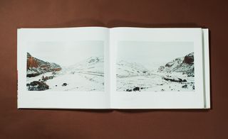 Double page photo of a landscape featuring a snow covered park / mountain area.