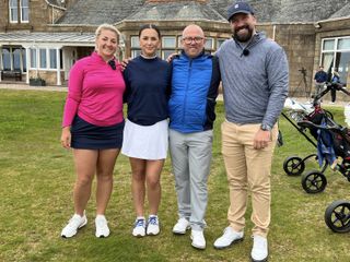 Four golfers pose for a photo before their round