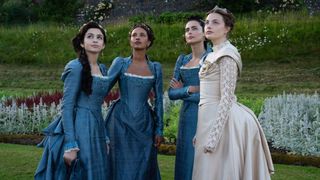 The Buccaneers cast standing in a row in blue and cream corset dresses 