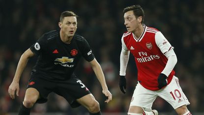Arsenal’s Mesut Ozil (right) in action against Manchester United in the Premier League