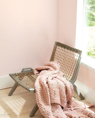Pale pink color on wall behind woven occasional chair