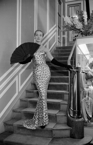 A model wearing a Pierre Balmain evening dress from his Autumn / Winter collection, Paris, August 1953. Original Publication: Picture Post - 6685 - Paris Picks Up Her Skirts - pub. 29th August 1953