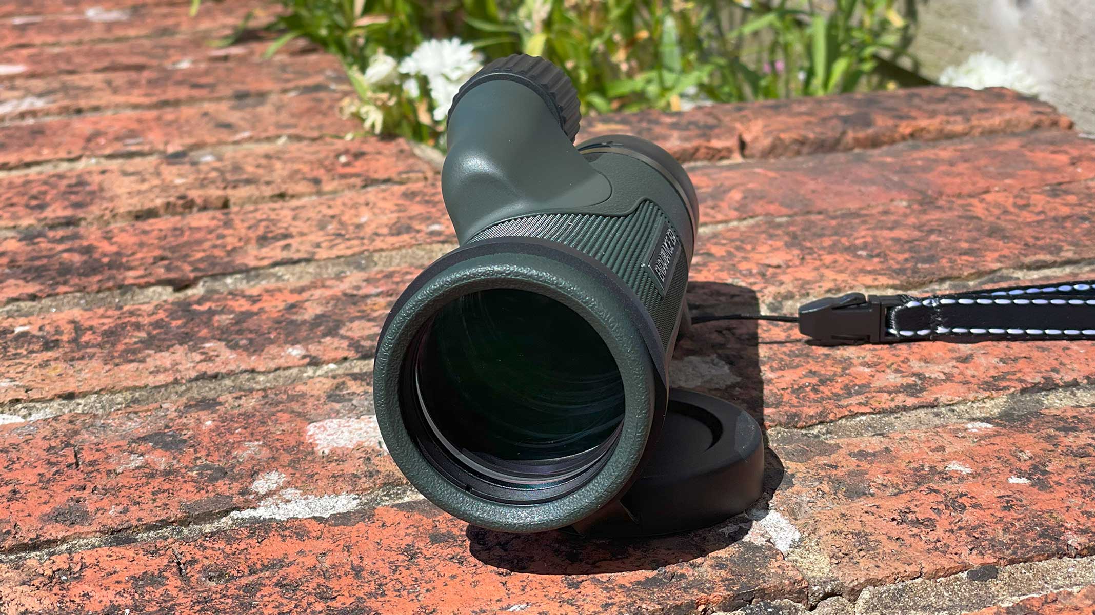 The Hawke Endurance 10x42 monocular facing forward on a brick wall.