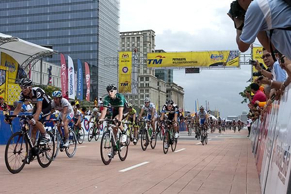 The rest of the field pass under the banner in Putrajaya at the completion to the sixth stage of the ten stage tour.