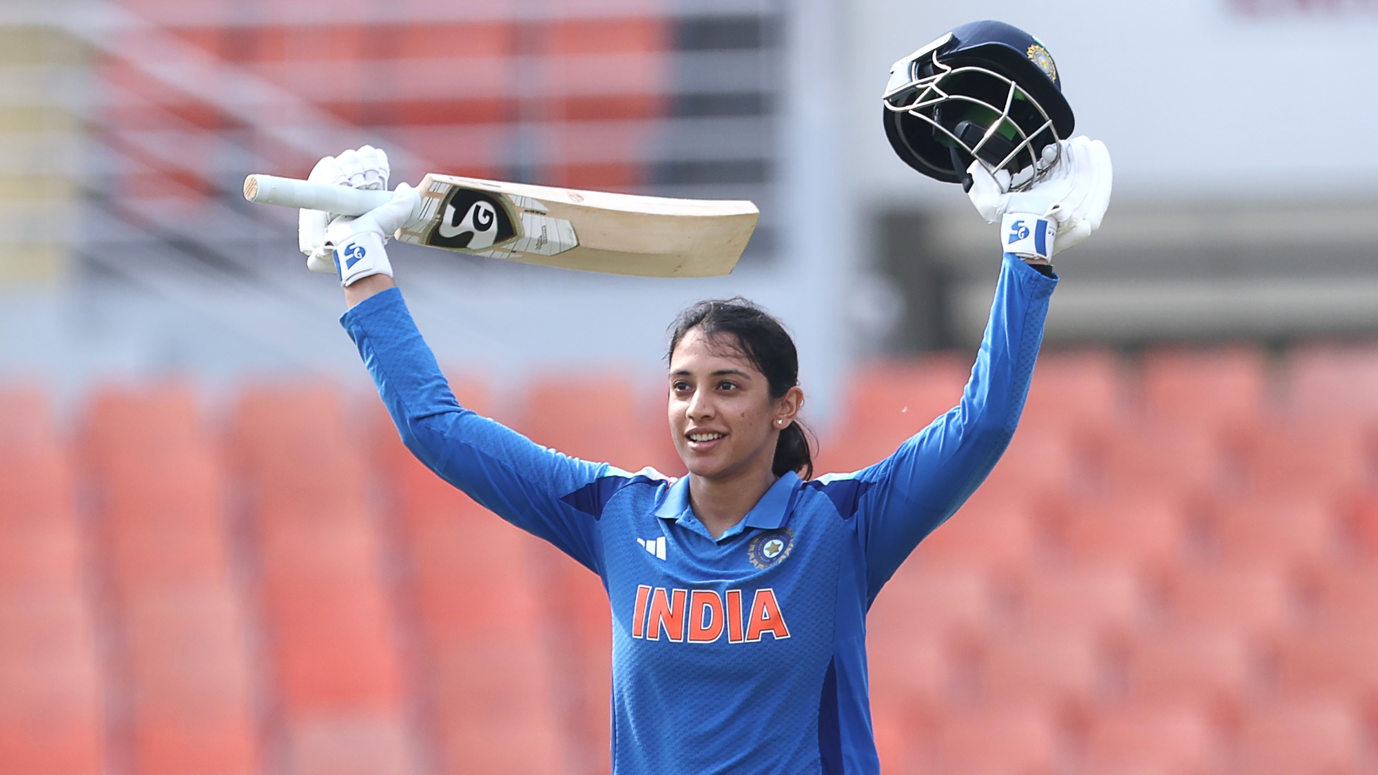 Smriti Mandhana of India celebrates after scoring a hundred during game two of the Women's ODI series between India and Australia at Maharaja Yadavindra Singh International Cricket Stadium on September 17, 2025 in Chandigarh, India.