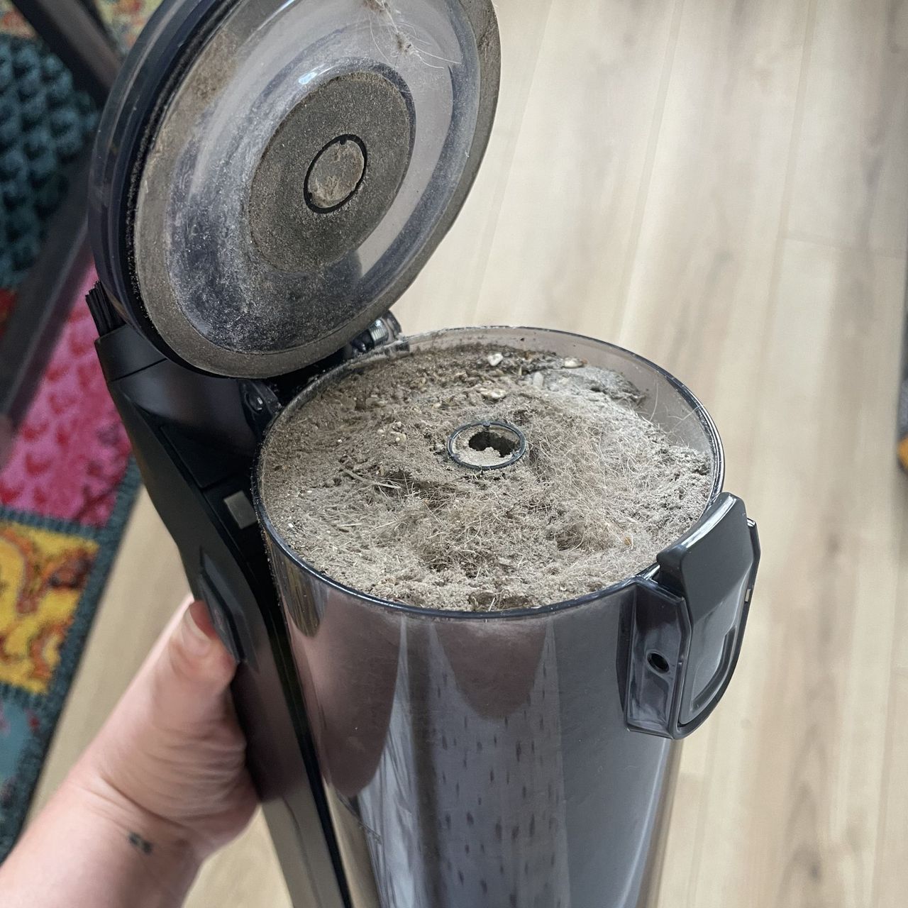 Full dust canister of the Hoover HF3 Pet DynamicClean Cordless Vacuum Cleaner