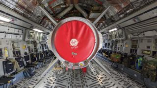 The thurster has a red cover over the base with the Virgin Orbit logo at the center.