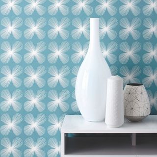 Habitat Opal large white glass bottle vase on white cabinet infront of blue and white wallpaper