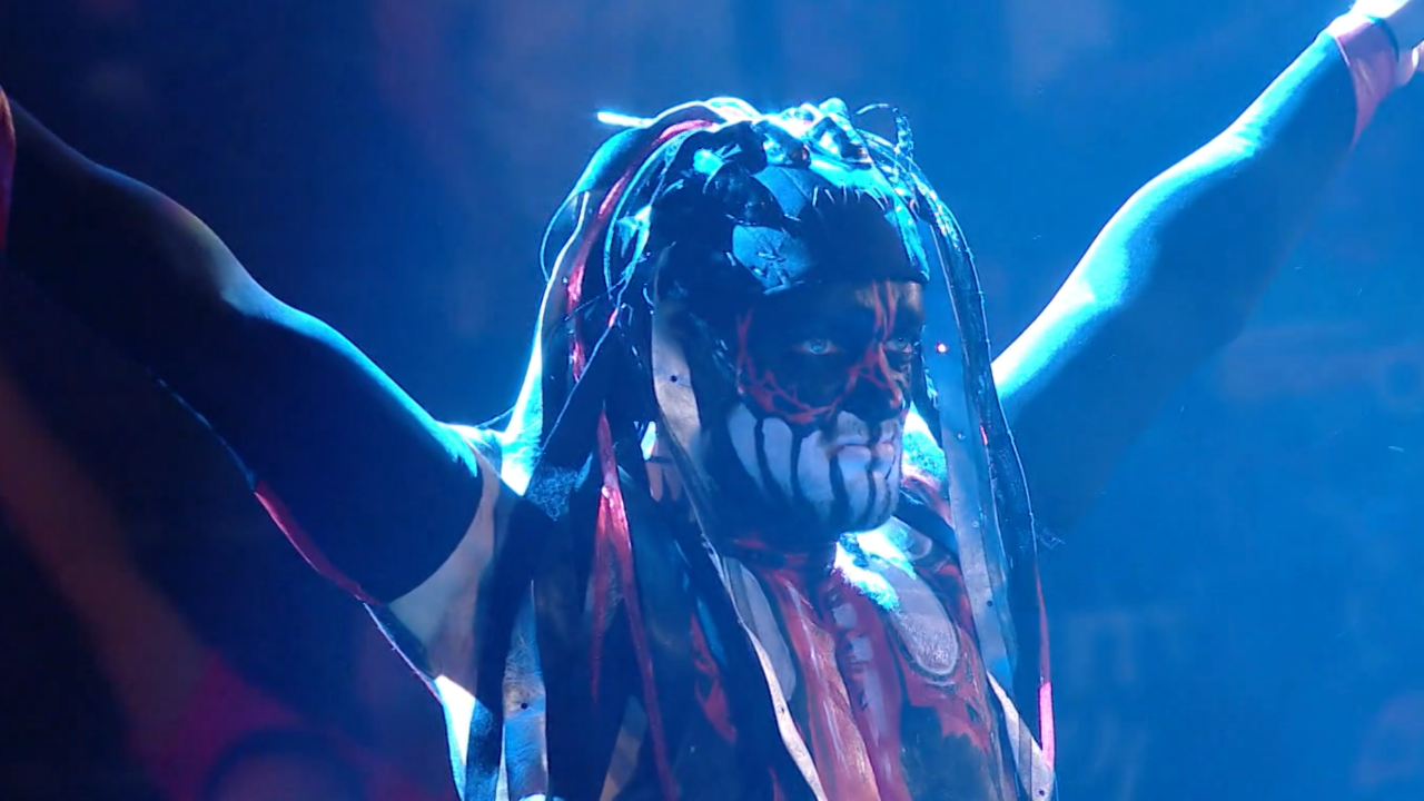 Finn Balor climbs the ropes while dressed as the Demon.