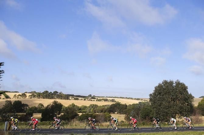 The peloton ride under blue skies.