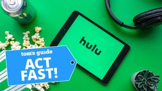 Hulu logo shown on a tablet with popcorn, headphones, and soda next to it