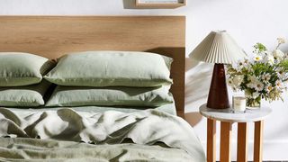 sage green bedding on a bed